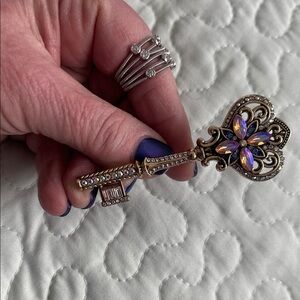 Ornate Key-Shaped Brooch with Purple Accents